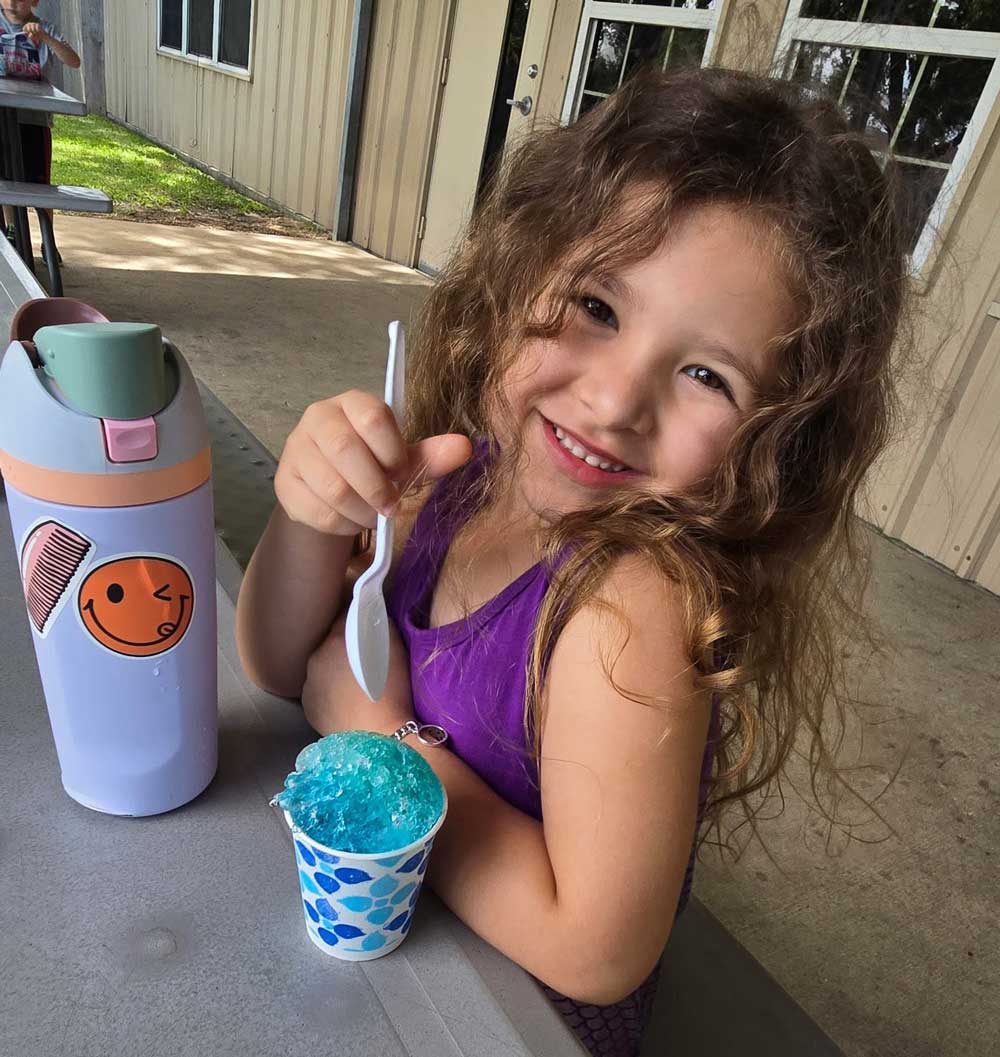 Child enjoying a summer treat at after-school care program